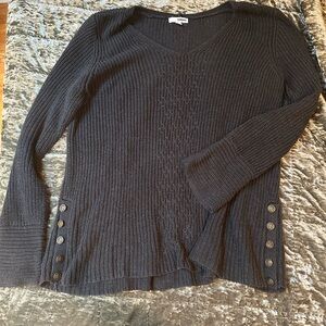 Grey sweater with button detailing.